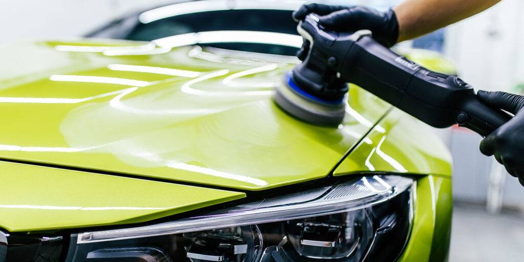 How to Do Car Polishing? New Beginner's Guide: 11 Car detailing - Worker with orbital polisher in auto repair shop